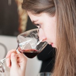 a woman drinking a glass of wine